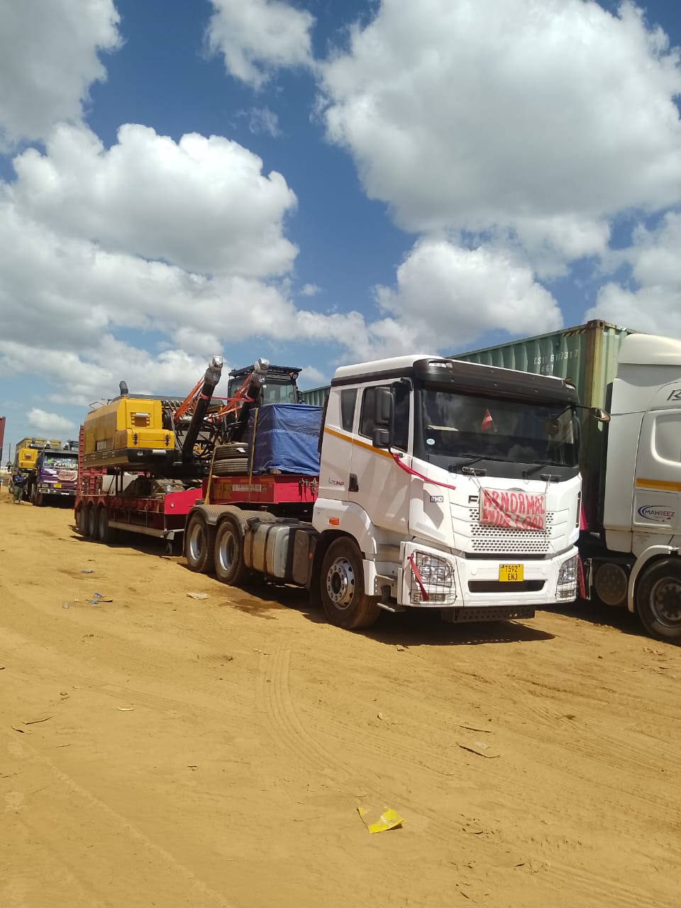 Flatbed truck hauling heavy machinery